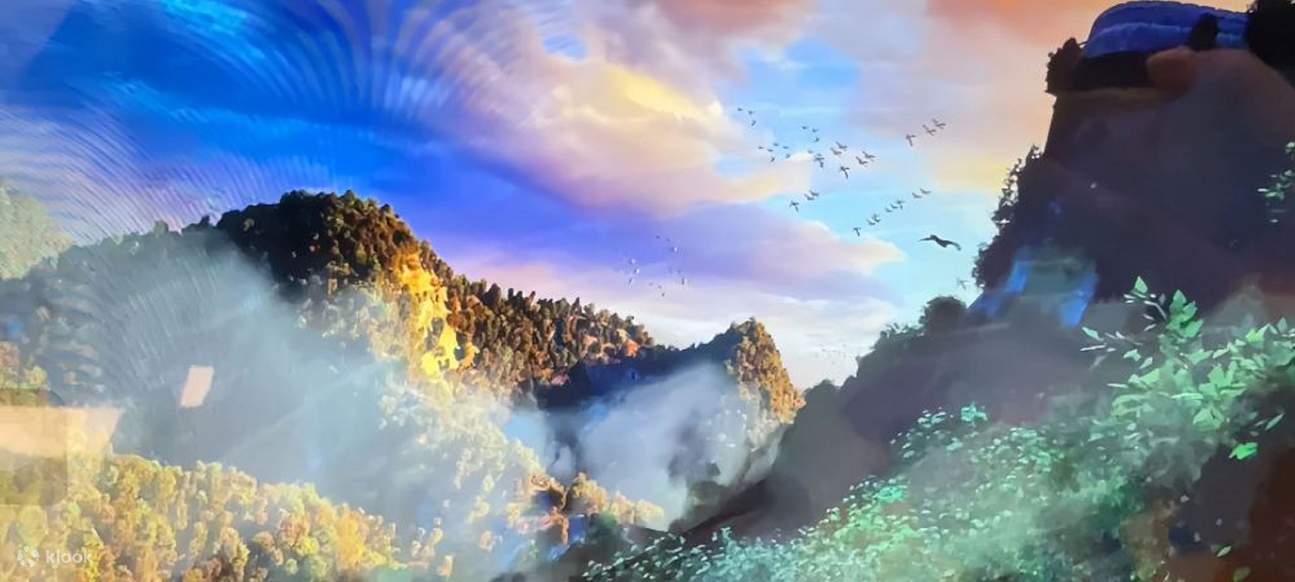 The mountains are half-covered by mist, with the tops tinged with golden and dark green hues.